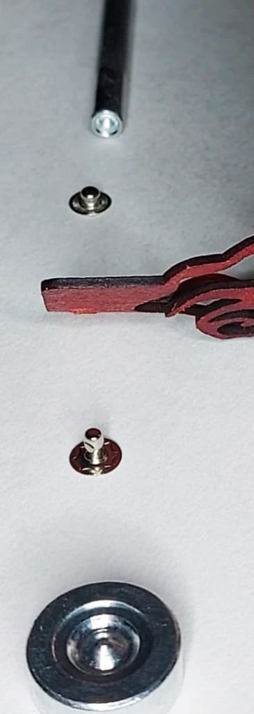 Placement of eyelet and stud Shows the correct placement of each component, layered from bottom to top: base, eyelet, leather, stud, concave installation tool.